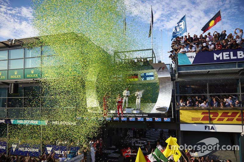 Confetti showers the top three drivers on the podium