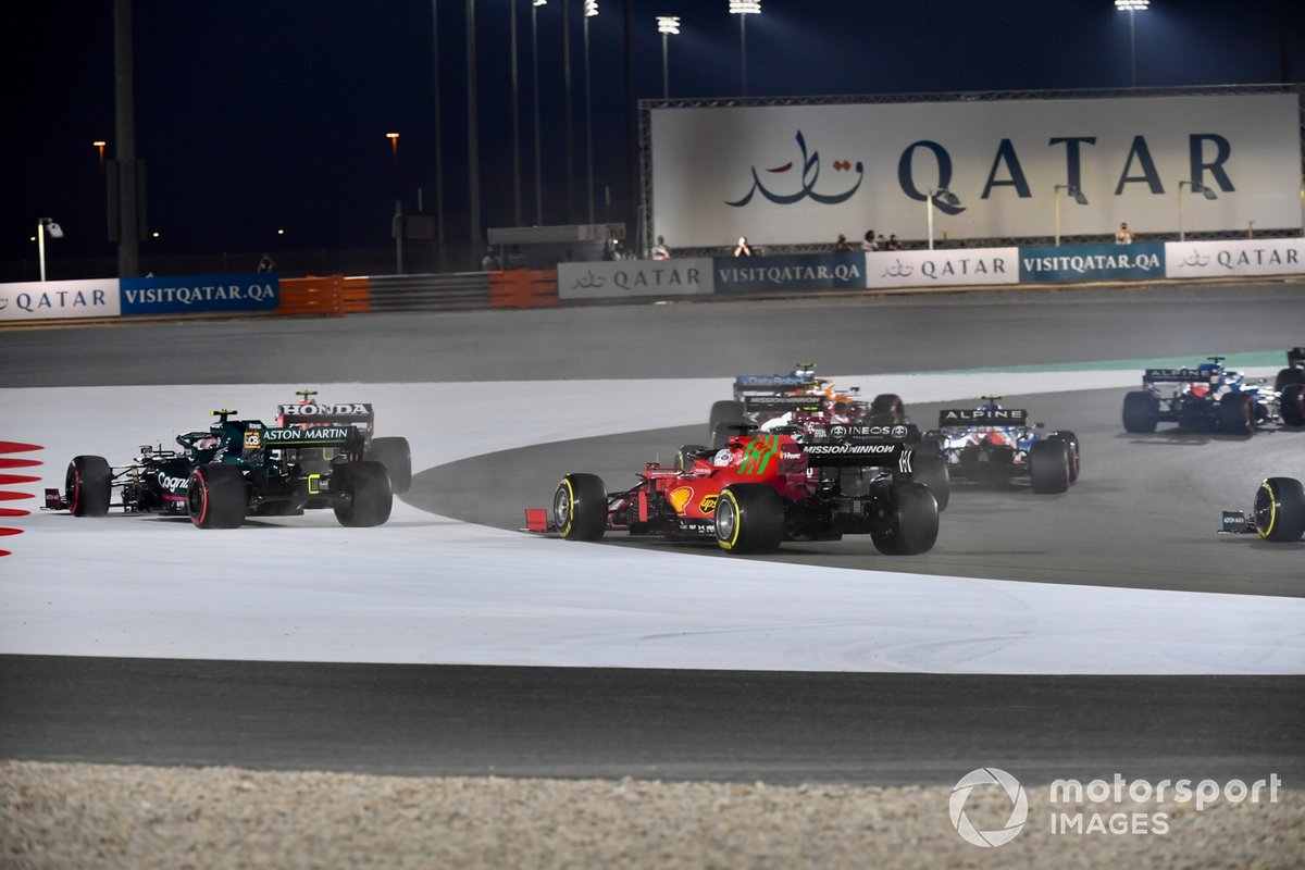 Sergio Perez, Red Bull Racing RB16B, and Sebastian Vettel, Aston Martin AMR21, run wide ahead of Charles Leclerc, Ferrari SF21, at the start