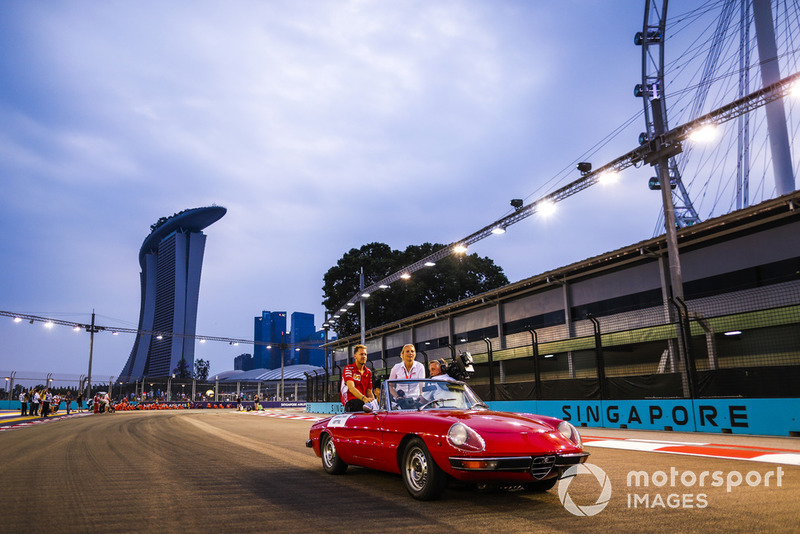 Sebastian Vettel, Ferrari, is filmed in an Alfa Romeo Spyder on the drivers' parade