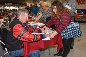 Larry Caudill signs autograph for fan