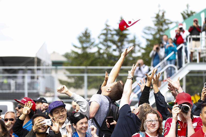 A cap is thrown towards an excited crowd