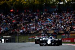 Felipe Massa, Williams FW38, leads Romain Grosjean, Haas VF-16
