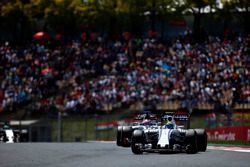 Felipe Massa, Williams FW38, leads Romain Grosjean, Haas VF-16