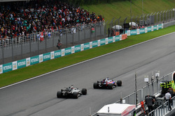 Pierre Gasly, Scuderia Toro Rosso STR12 and Romain Grosjean, Haas F1 Team VF-17