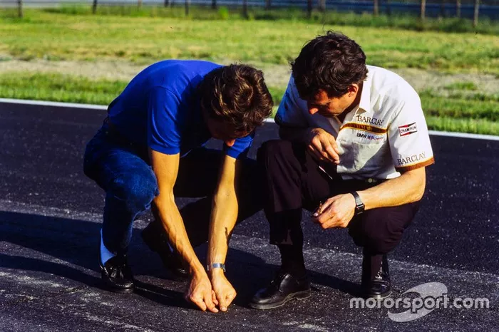 Gerhard Berger examina el estado del asfalto con Jackie Oliver