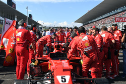 Ferrari-monteurs bekijken de wagen van Sebastian Vettel, Ferrari SF70H, vanwege technische problemen