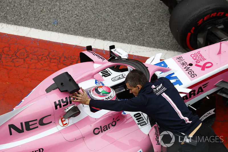 Sergio Perez, Force India, is pushed into his garage in the pit lane