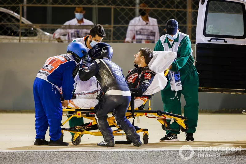 Medical delegates assist Romain Grosjean, Haas F1, after a huge crash on the opening lap