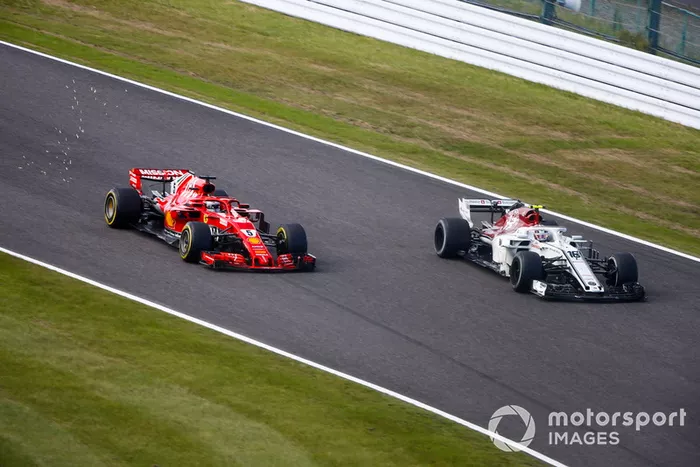 Sebastian Vettel, Ferrari SF71H, passes Charles Leclerc, Sauber C37