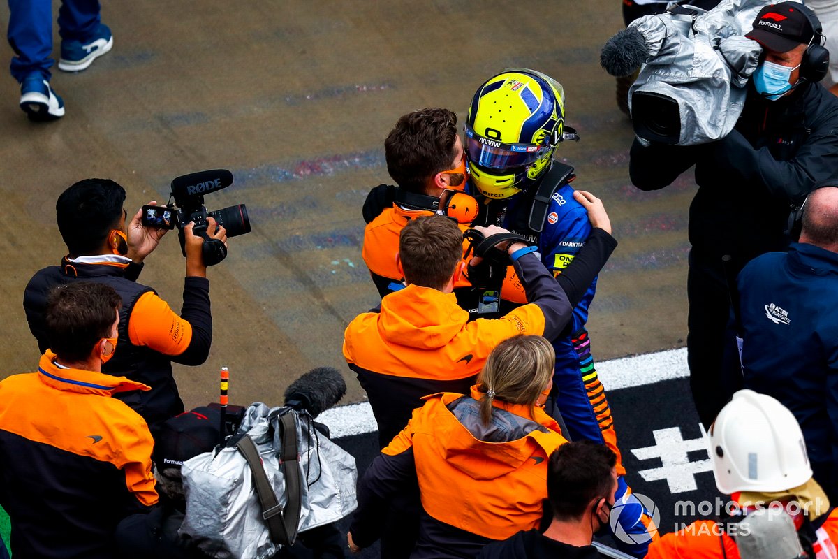 Lando Norris, McLaren, celebrates with a team mate after securing pole