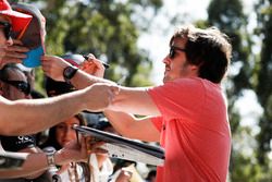 Fernando Alonso, McLaren, signs autographs for fans