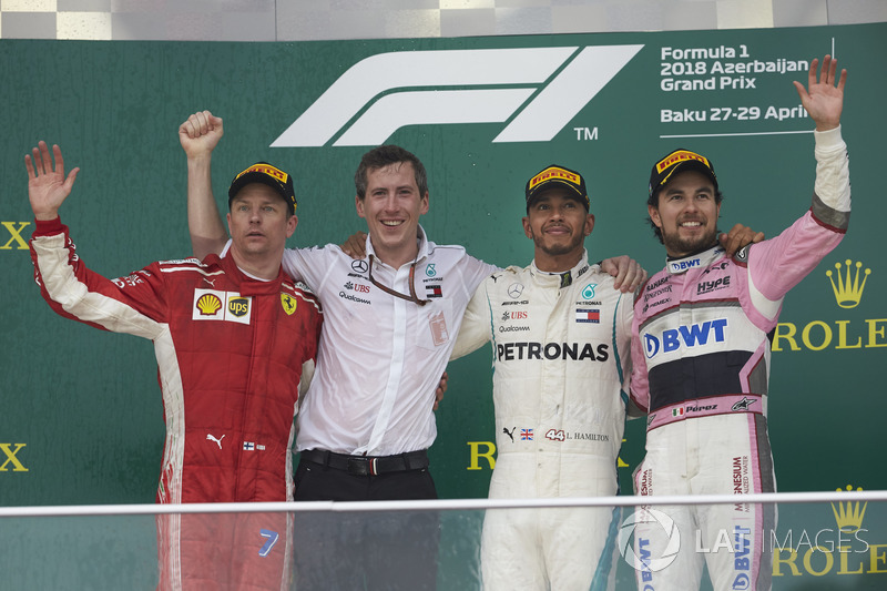 Kimi Raikkonen, Ferrari, 2nd position, the Mercedes Constructors delegate, Lewis Hamilton, Mercedes AMG F1, 1st position, and Sergio Perez, Force India, 3rd position, on the podium