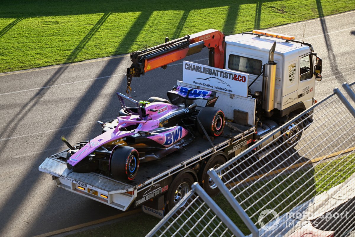 Marshals remove the damaged car of Pierre Gasly, Alpine A523, with a truck after the race