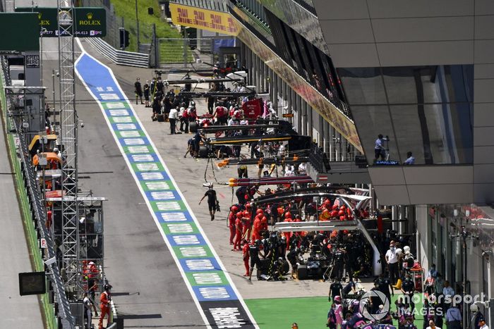 Pit crews at work in the pit lane