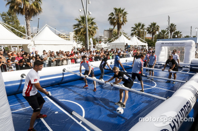 Drivers playing life size table soccer