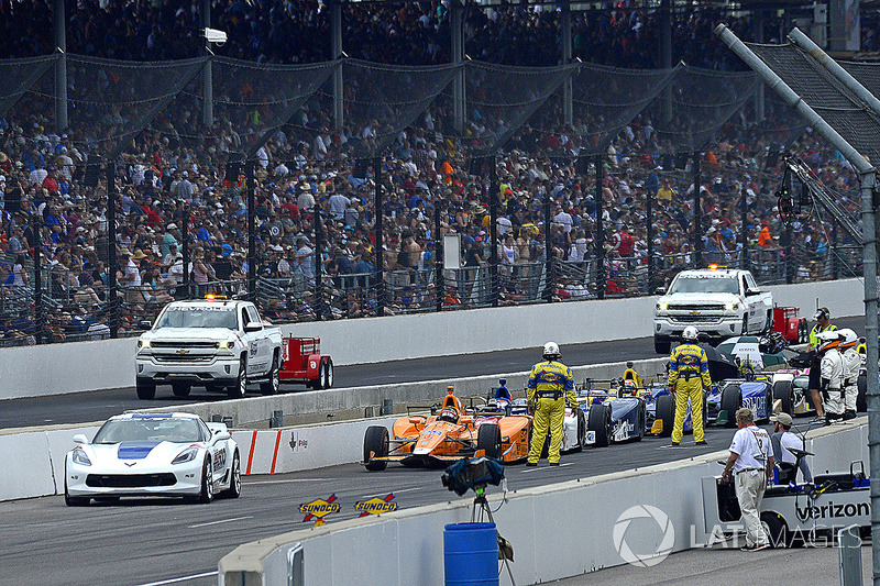 Fernando Alonso, Andretti Autosport Honda and the rest of the field wait during a red flag period