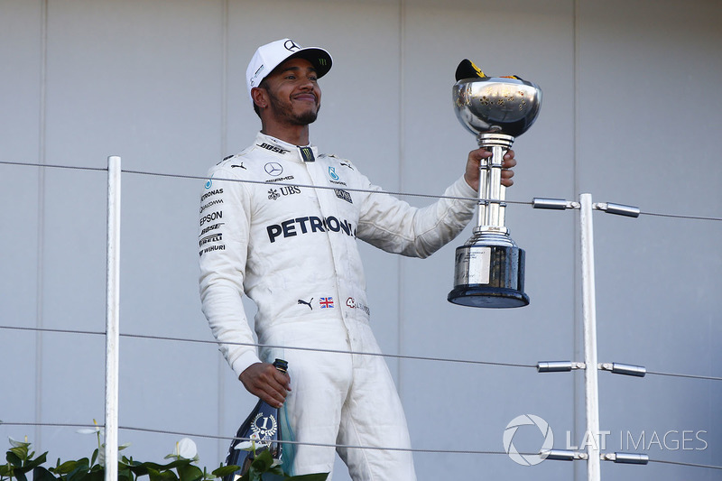 Race winner Lewis Hamilton, Mercedes AMG F1, leaves the podium with his trophy