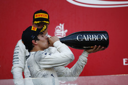 Lance Stroll, Williams, drinks champagne on the podium ahead of Valtteri Bottas, Mercedes AMG F1
