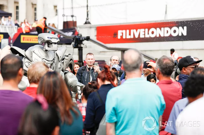 A robotic performer mingles, the crowd