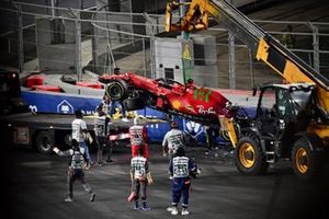 Marshals remove the damaged car of Charles Leclerc, Ferrari SF21, from the circuit