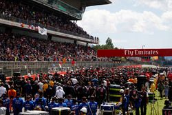 The grid stands to attention for the national anthem