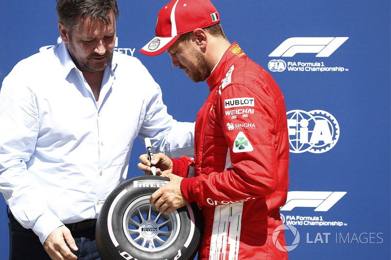 Sebastian Vettel, Ferrari, signs the Pirelli Pole Position Award as Paul Hembrey, Director, Pirelli 