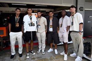 Jude Bellingham, Levi Colwill, Reece James, Morgan Gibbs-White, Eberechi Eze, James Trafford pose for a photo outside the McLaren garage 