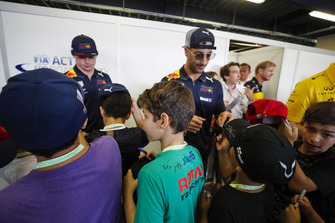 Max Verstappen, Red Bull Racing, and Daniel Ricciardo, Red Bull Racing, sign autographs for young fans