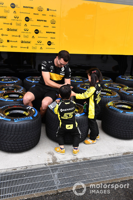 Renault Sport F1 Team mechanic with Pirelli tyres and young fans