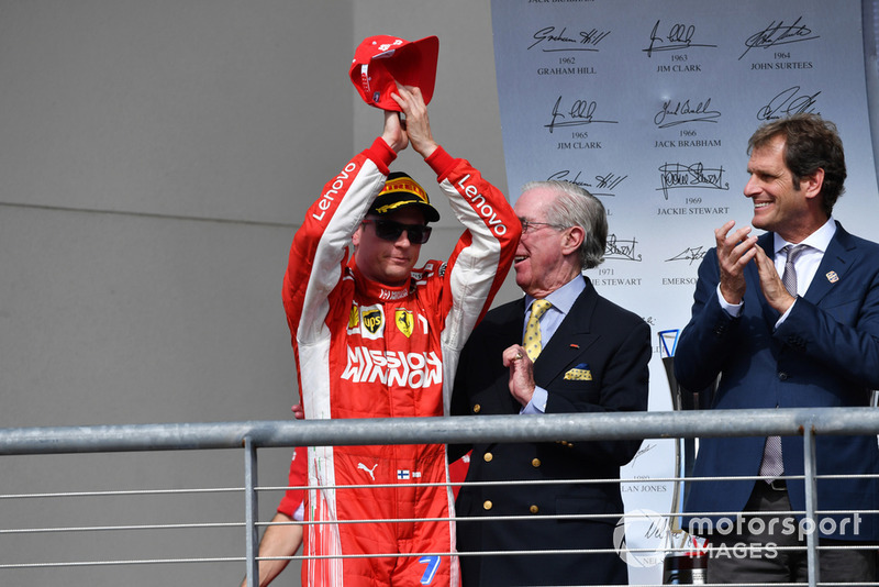 Race winner Kimi Raikkonen, Ferrari celebrates on the podium