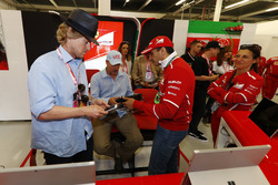 Owen Wilson and Woody Harrelson receive a tour of the Ferrari garage from Sergio Marchionne, Chief E