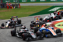 Fernando Alonso, McLaren MP4-31 and Pascal Wehrlein, Manor Racing MRT05 at the start of the race