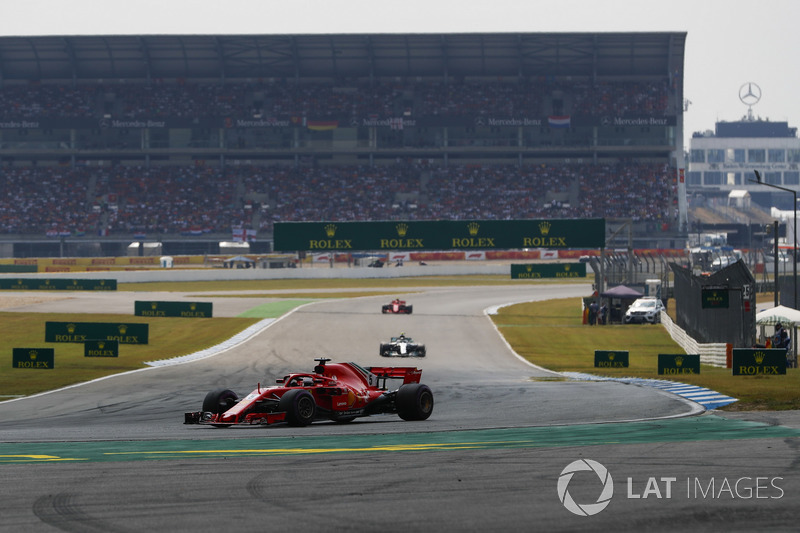 Sebastian Vettel, Ferrari SF71H, leads Valtteri Bottas, Mercedes AMG F1 W09, and Kimi Raikkonen, Ferrari SF71H