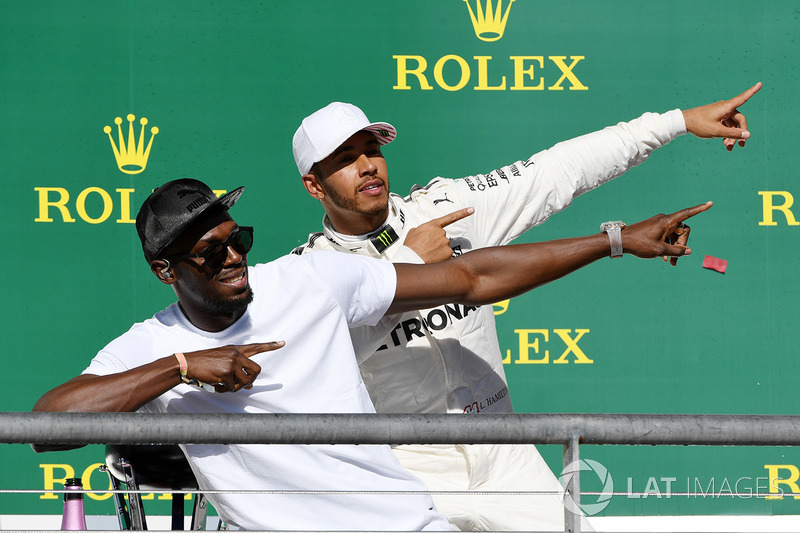 Race winner Lewis Hamilton, Mercedes AMG F1 celebrates on the podium with Usain Bolt