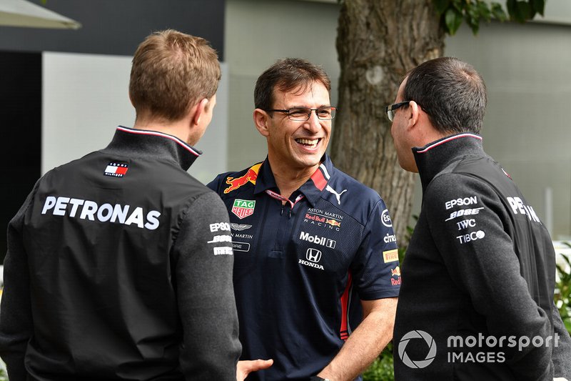 Mercedes and Red Bull personnel talk in the paddock