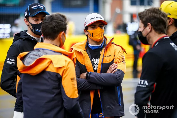 George Russell, Williams Racing, Carlos Sainz Jr., McLaren, and Romain Grosjean, Haas F1, on the grid