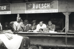 Zusammen mit Freunden verbringt Hans Rüesch 1934 eine Trainingspause in den Boxen von Bern. Vor ihm steht der Maserati 4CS, an dessen Steuer er das Rennen der