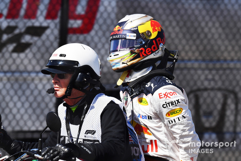 Daniel Ricciardo, Red Bull Racing on the back of a motorbike after retiring