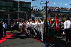 The drivers as the grid observes the national anthem