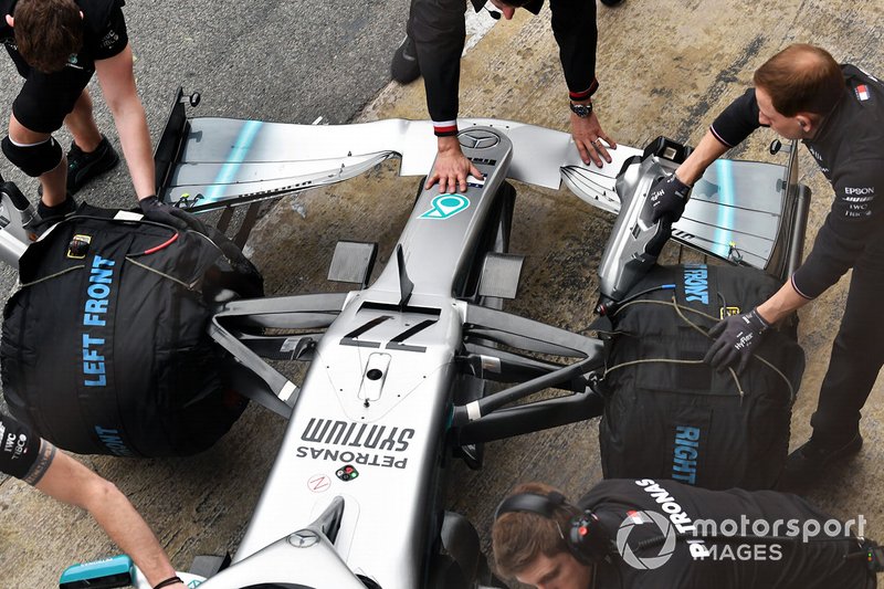 Team members push the car of Valtteri Bottas, Mercedes AMG F1 W10, into the garage