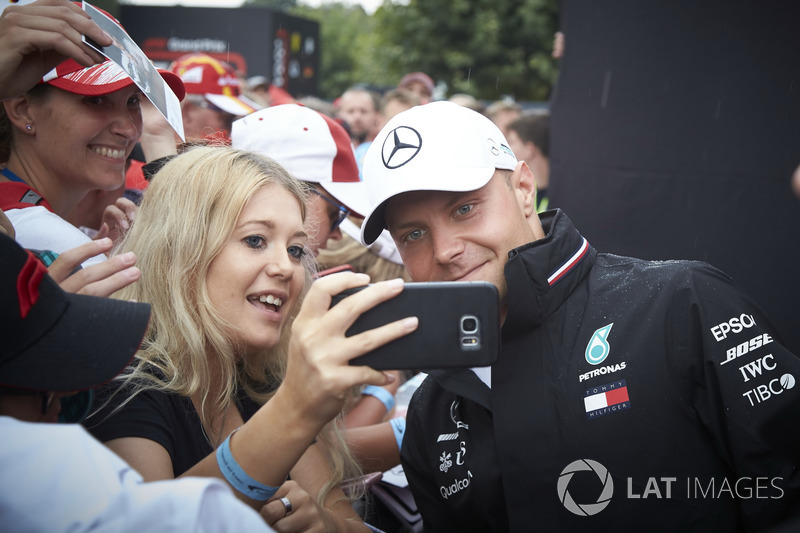 Valtteri Bottas, Mercedes AMG F1, has his photo taken with a fan