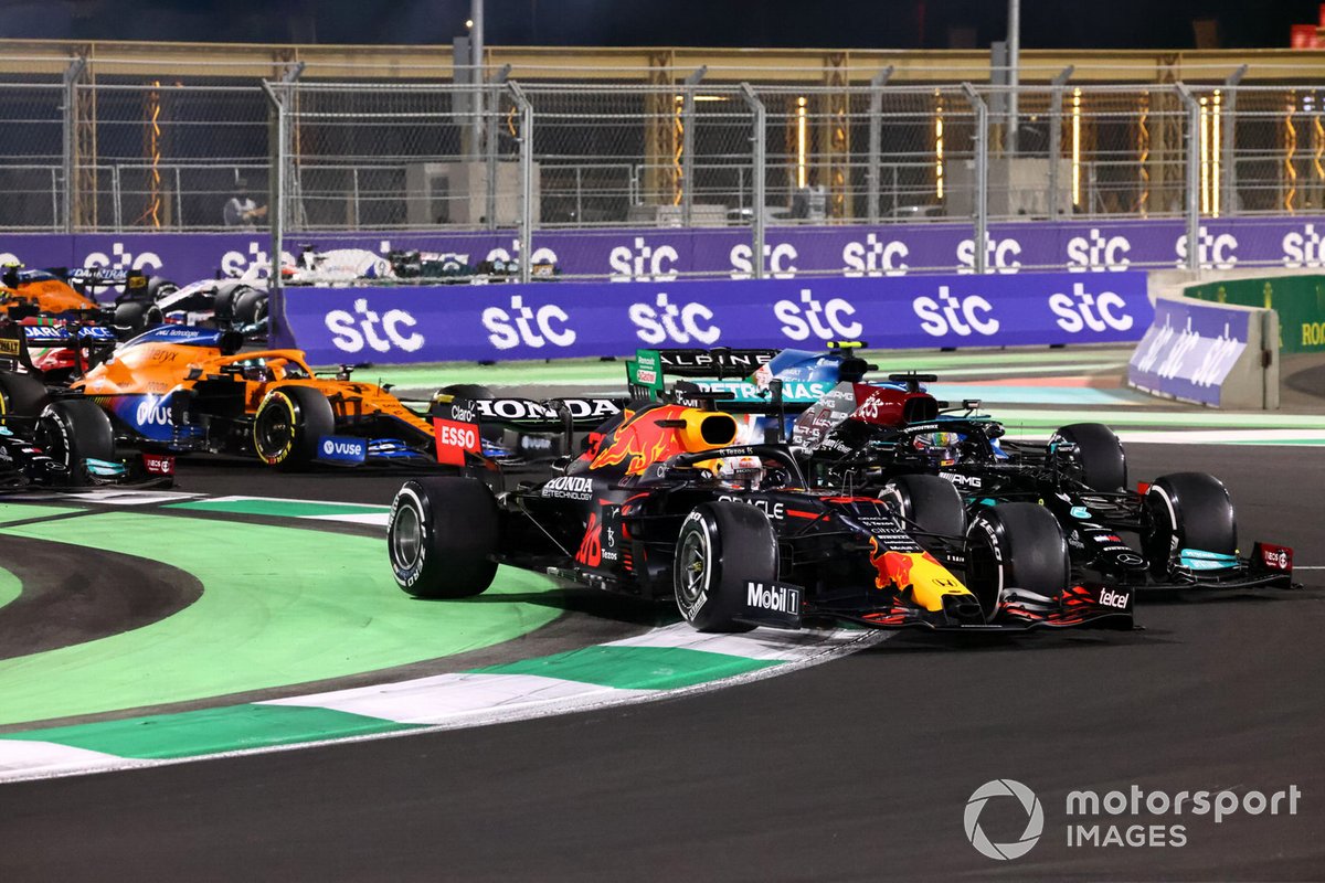 Max Verstappen, Red Bull Racing RB16B, and Lewis Hamilton, Mercedes W12, do battle at the restart