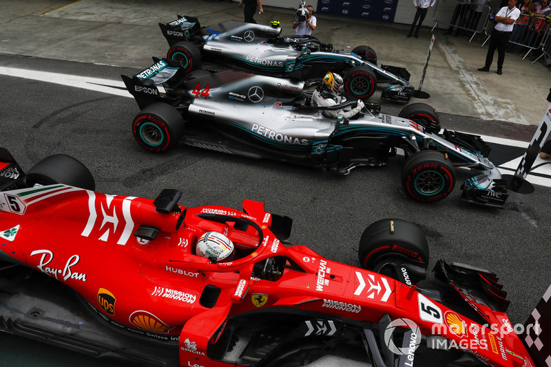 Lewis Hamilton, Mercedes AMG F1, celebrates pole position in parc ferme between Valtteri Bottas, Mercedes AMG F1 W09, and Sebastian Vettel, Ferrari SF71H.