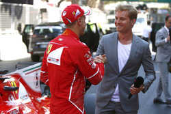 Race winner Sebastian Vettel, Ferrari, is interviewed by reigning World Champion Nico Rosberg