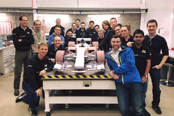 Manor wind tunnel model car with the team