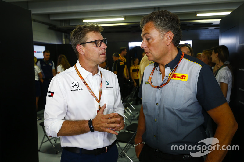 Mario Isola, Racing Manager, Pirelli Motorsport, talks to an AMG Mercedes team member