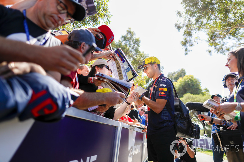 Daniel Ricciardo, Red Bull Racing, signs autographs for fans