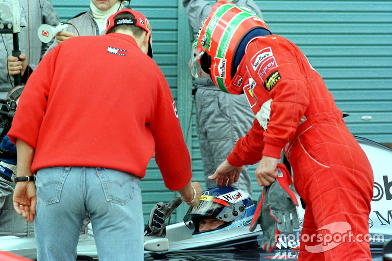 Ferrari drivers Michael Schumacher and Eddie Irvine congratulate the new Formula One World Champion 