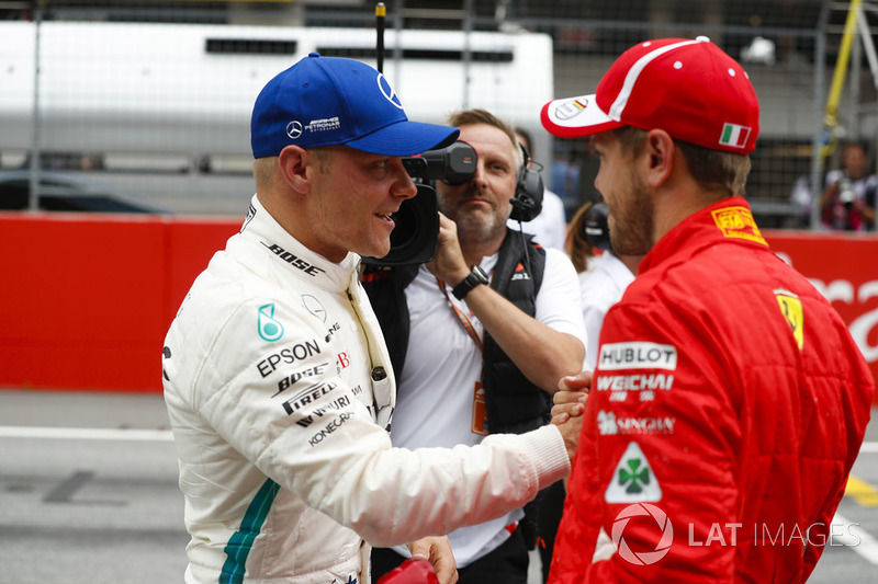 Pole sitter Valtteri Bottas, Mercedes AMG F1, is congratulated by third place Sebastian Vettel, Ferrari