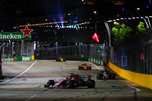 Sergio Perez, Racing Point Force India VJM11, leads Romain Grosjean, Haas F1 Team VF-18, and Fernando Alonso, McLaren MCL33